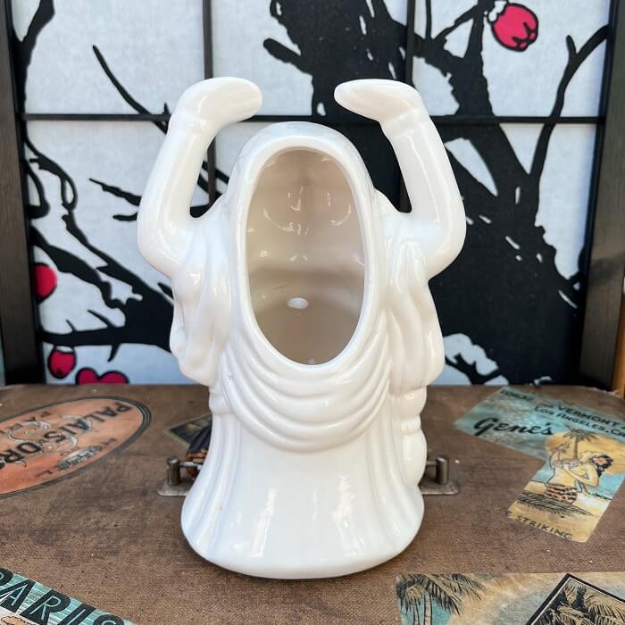 Rhino traveled back in time and found this lovely relic from Orchids of Hawaii. This White Buddha Tiki Mug was made in Taiwan and has a large opening in the back for pouring drinks and a small hole in the front for a straw! This mug is in great condition with no chips or cracks! Perfect for your home Tiki Bar or next cocktail party! He can't wait to come home with you 🍹 Shop Rhino and Lucy Tiki Mugs